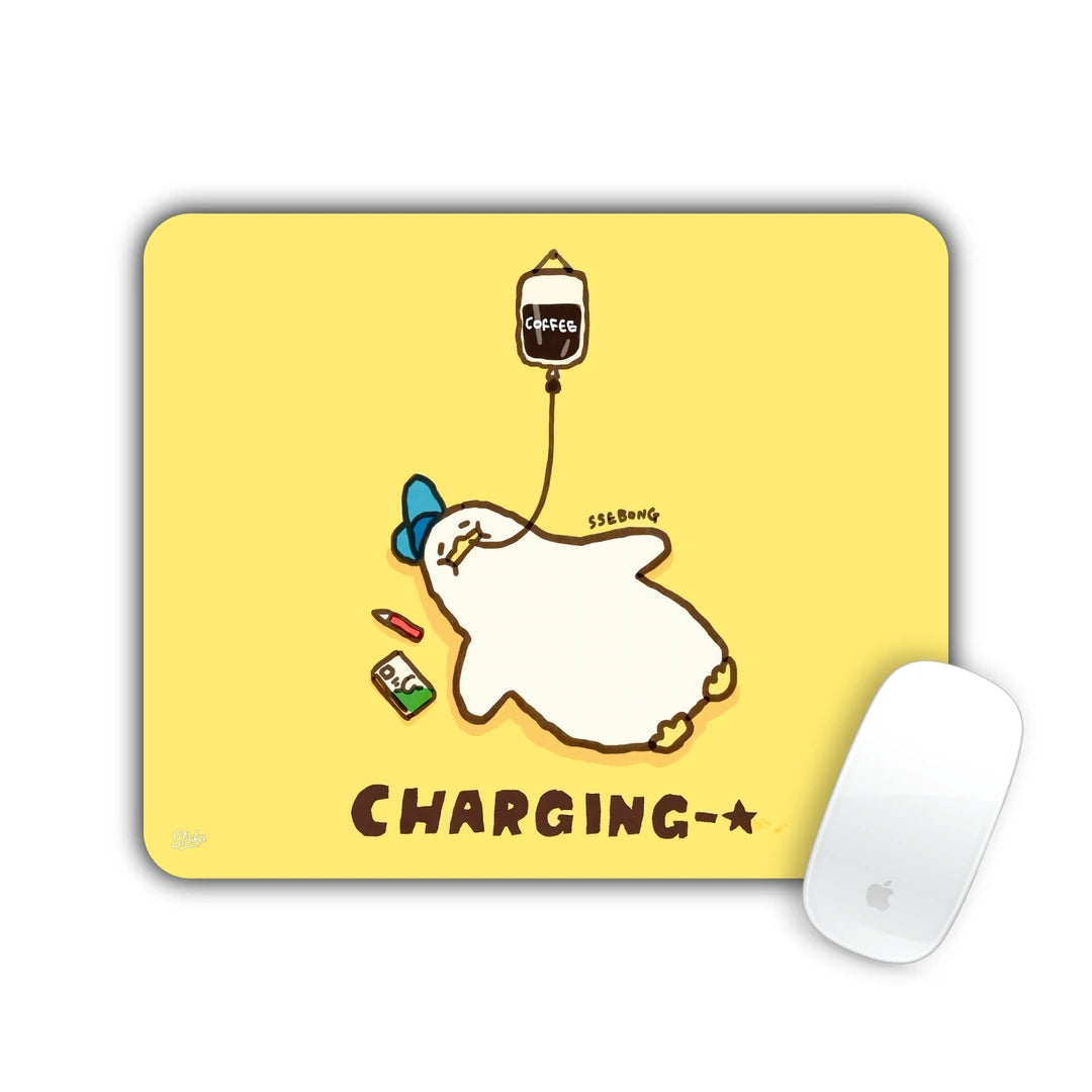 Duck lying flat with a coffee drip and 'CHARGING' text on yellow mouse pad 23x19