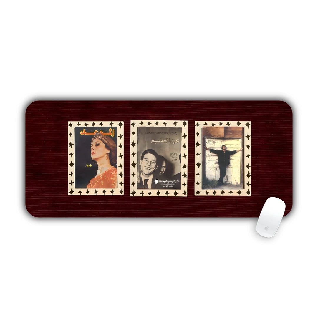 Three vintage framed black and white portraits on a dark red background desk pad 70x30