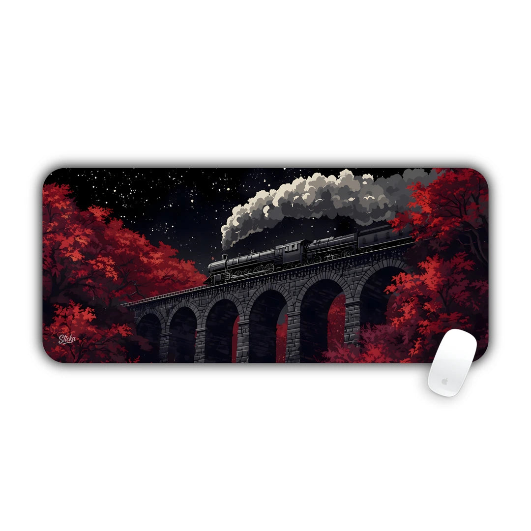 Steam locomotive crossing a high arched stone viaduct at night amid red trees desk pad 70x30