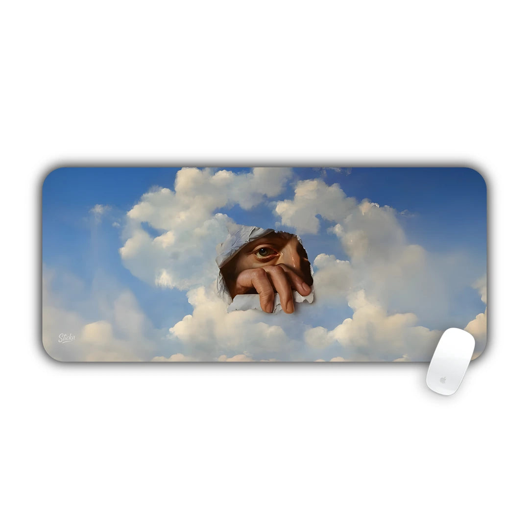 Surrealist painting of a human eye looking through a tear in blue cloudy sky desk pad 70x30