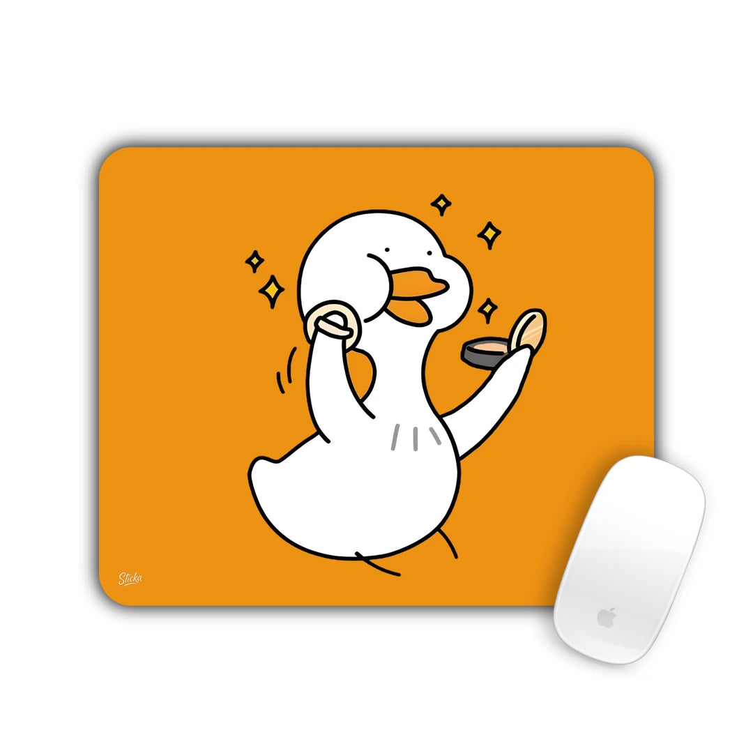 White duck dancing happily with a coin among sparkles on orange mouse pad 23x19