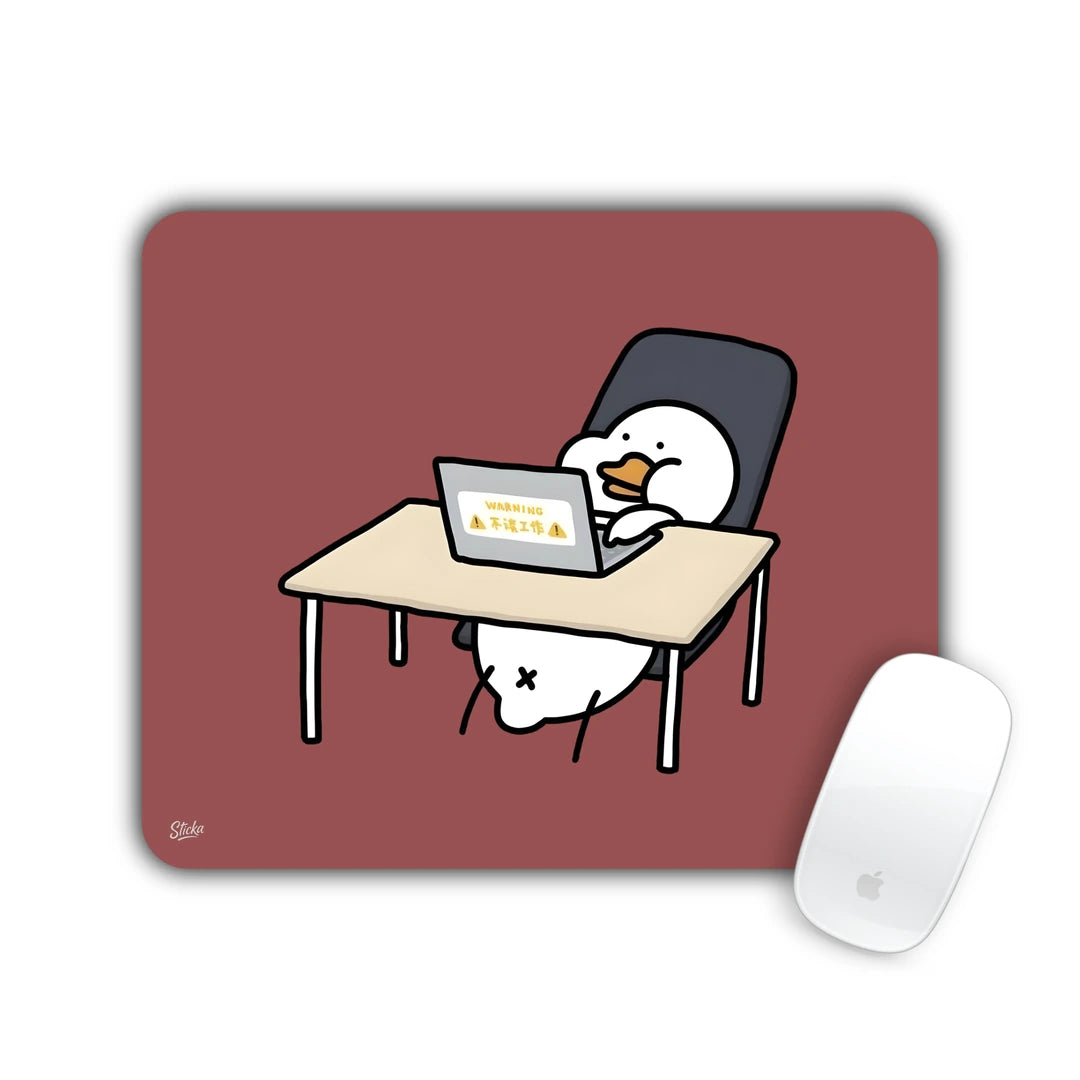 White blob character slumped at a desk with a laptop on maroon mouse pad 23x19