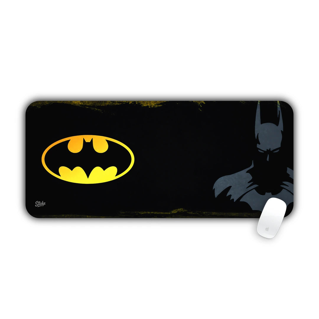 Yellow Batman oval symbol and dark silhouette of the Caped Crusader desk pad 70x30