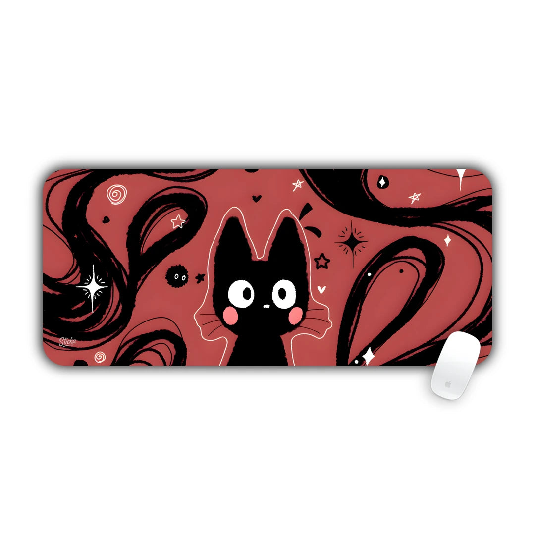 Cute black cat peeking through flowing black swirls on red starry background desk pad 70x30